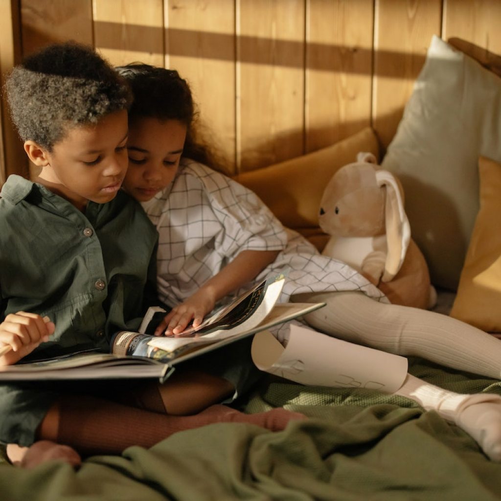 Two children reading in bed