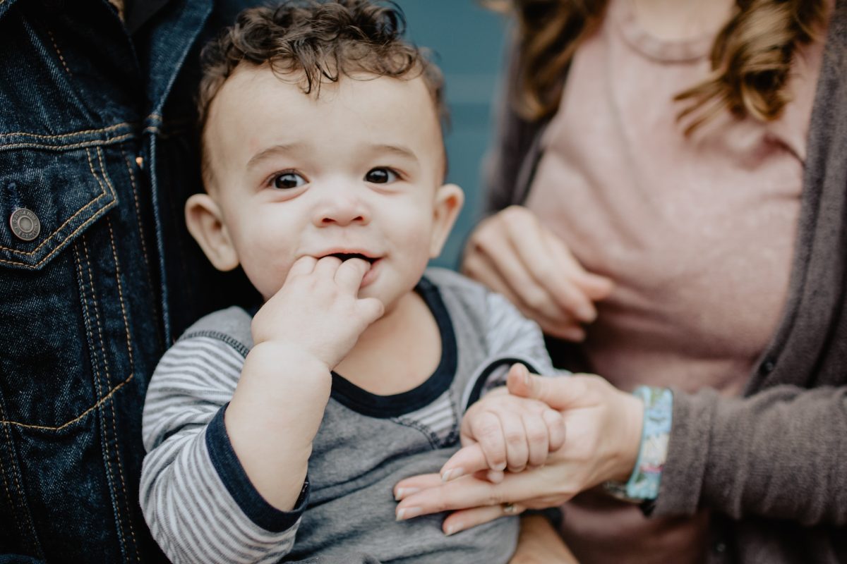 A small child chewing on their hand.