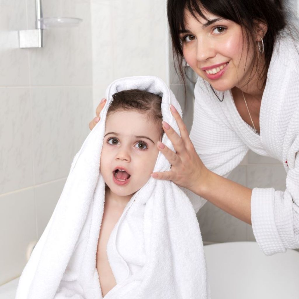 Mom drying a toddler's hair