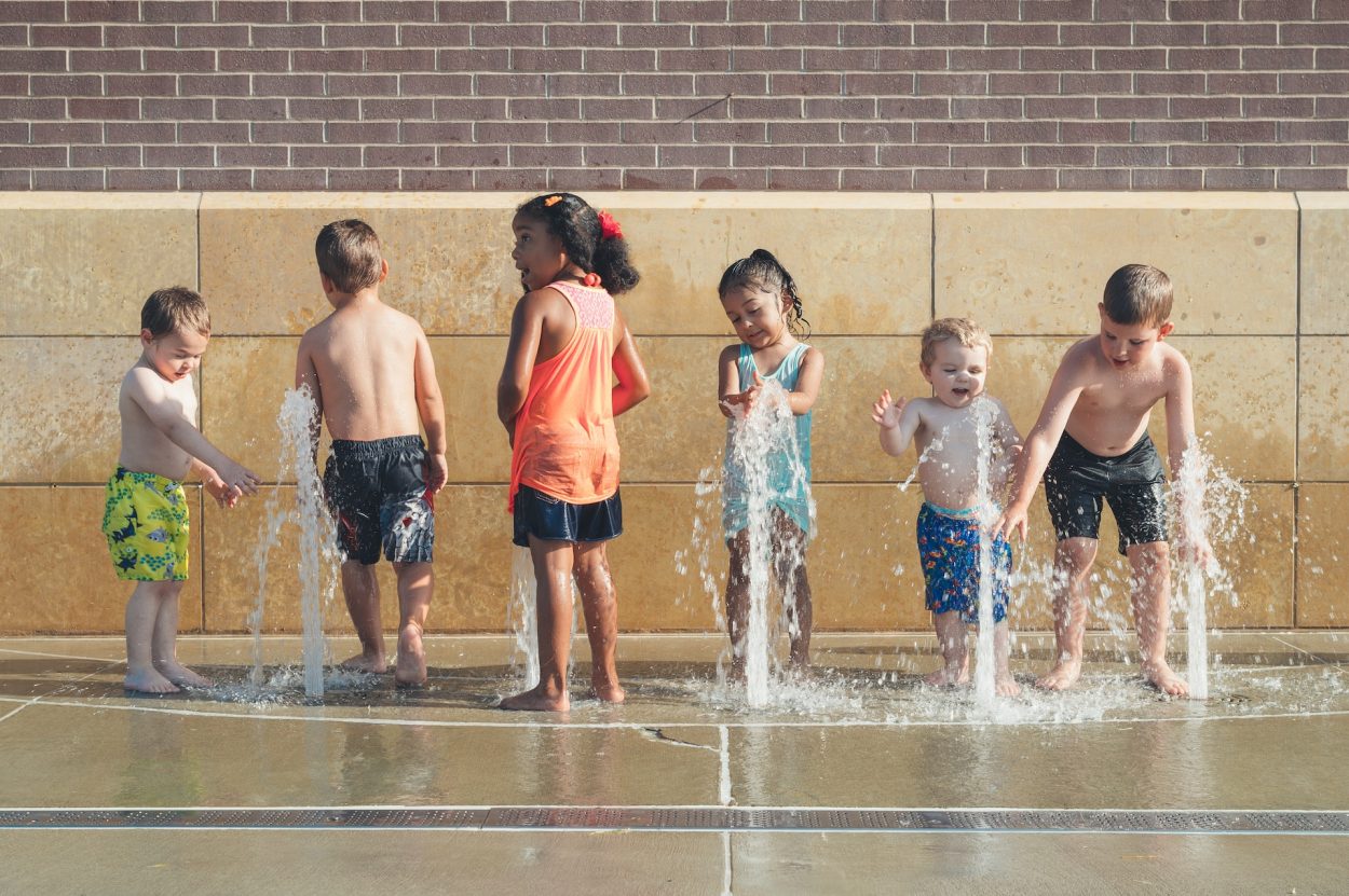 Kids playing outside at a splash pad