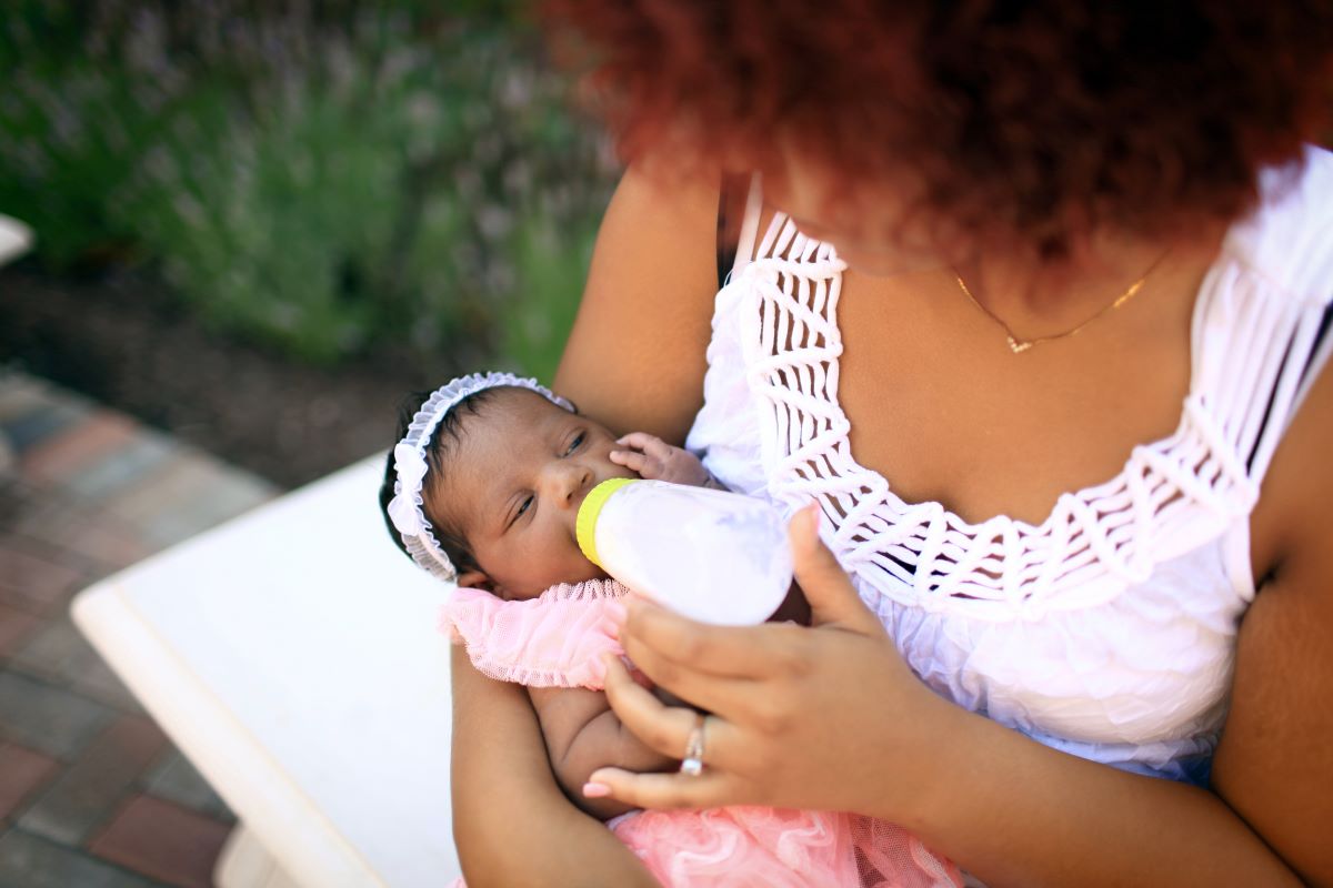 Mom feeding her baby outside
