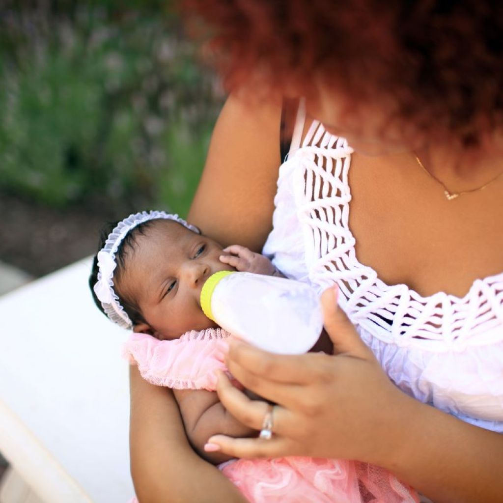 Mom feeding her baby outside