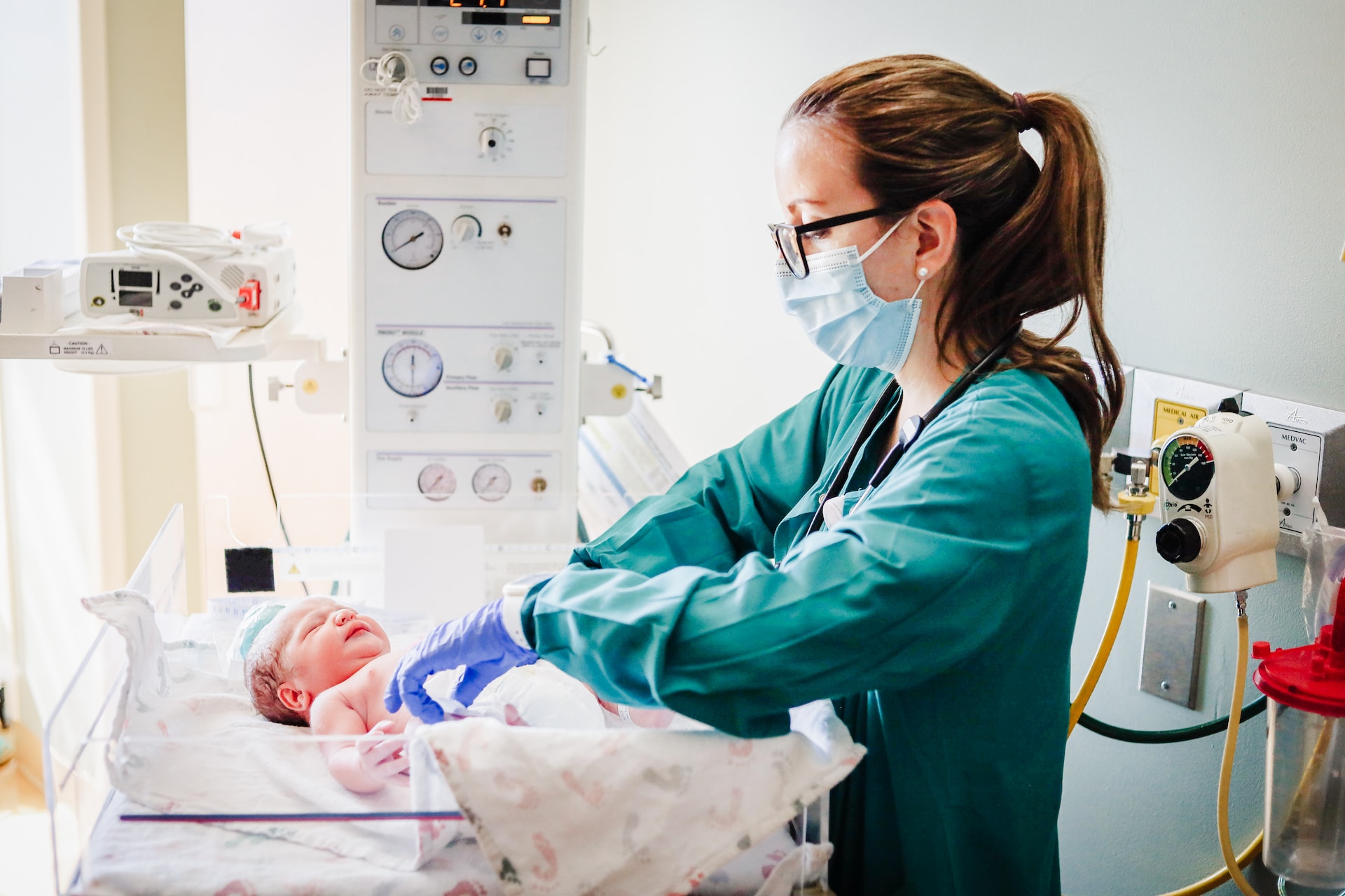 A nurse doing a check on a newborn