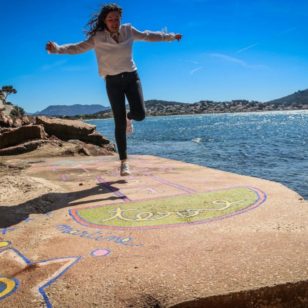 Teen enjoying herself playing hopscotch