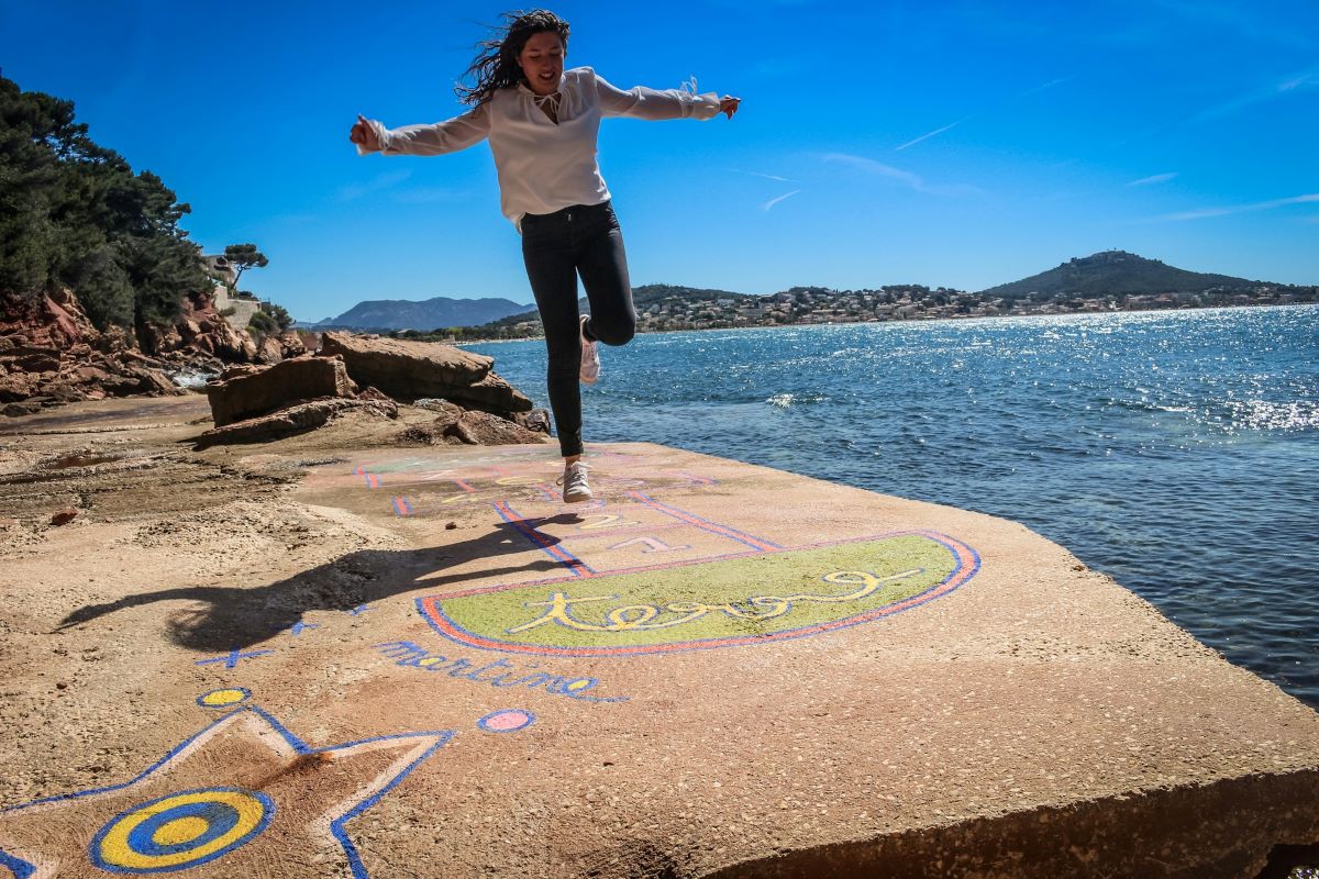 Teen enjoying herself playing hopscotch