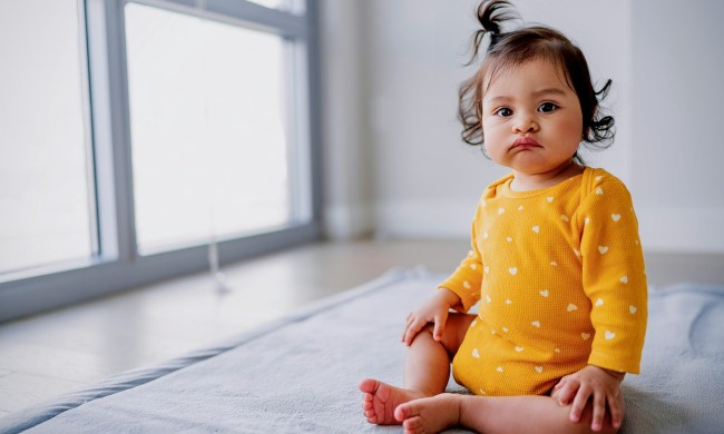 A baby sitting up looking at the camera
