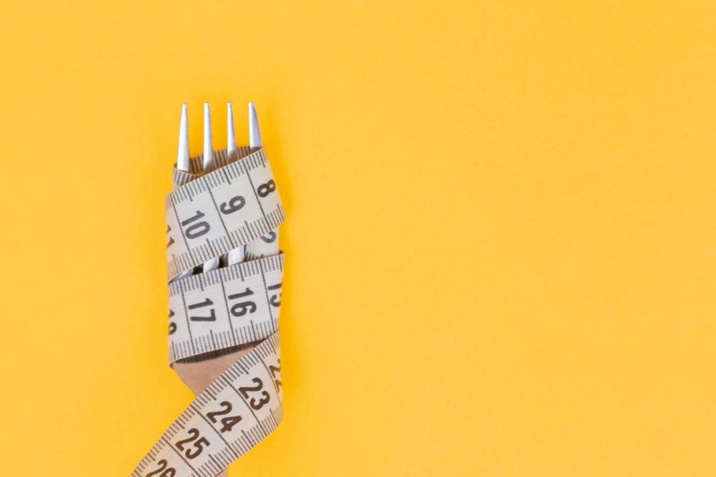 Measuring tape around a fork