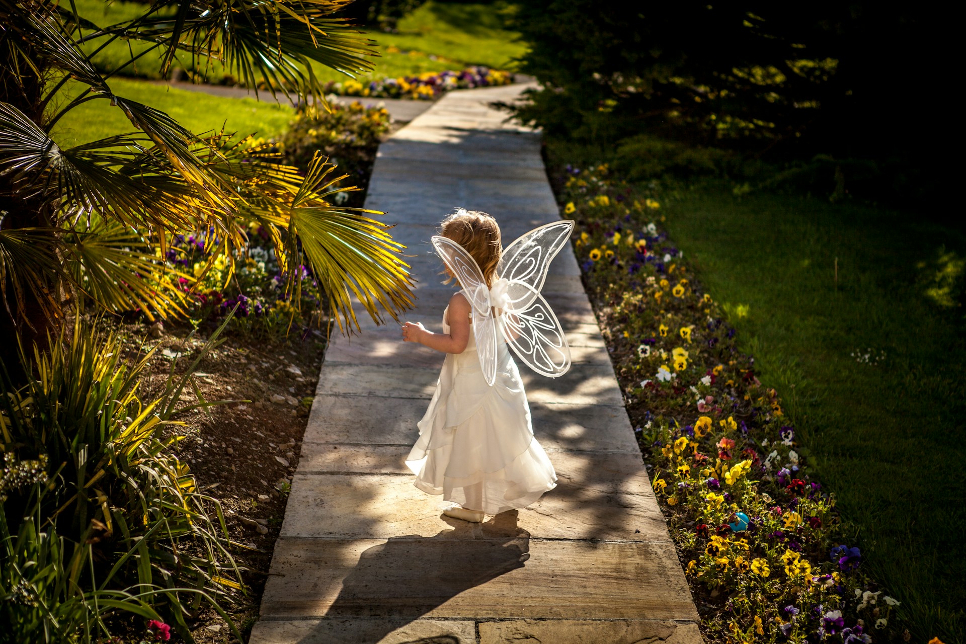 A child wearing butterfly wings.