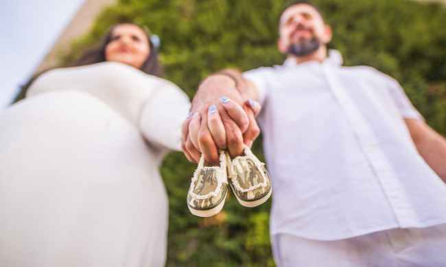 A couple baby announcement with small shoes