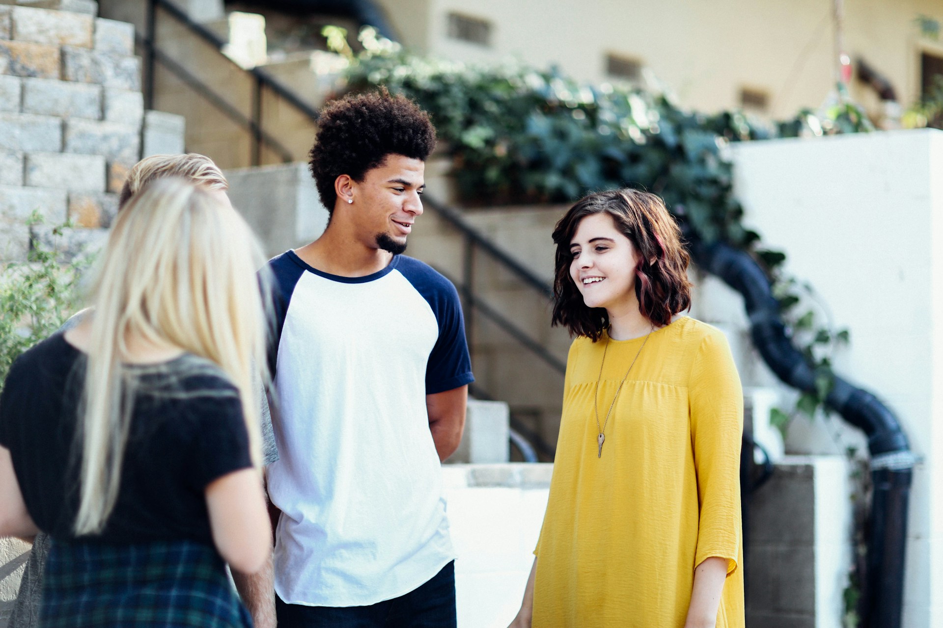 Teens standing outside talking.