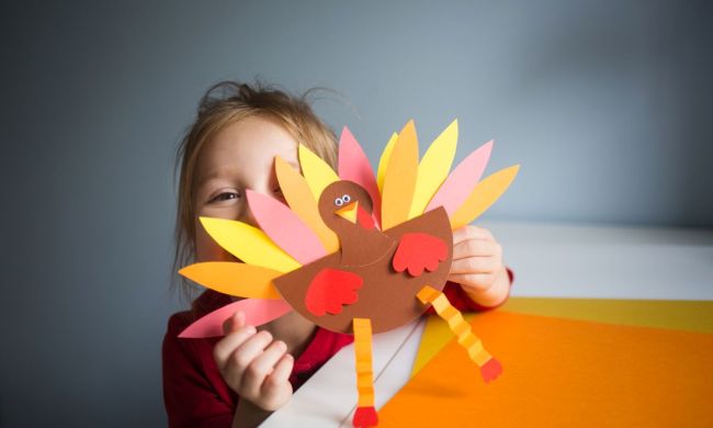 Little girl showing off her Thanksgiving turkey craft