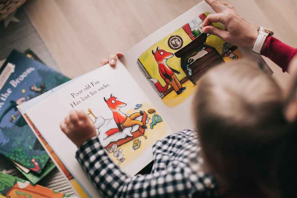 small child reading fox book
