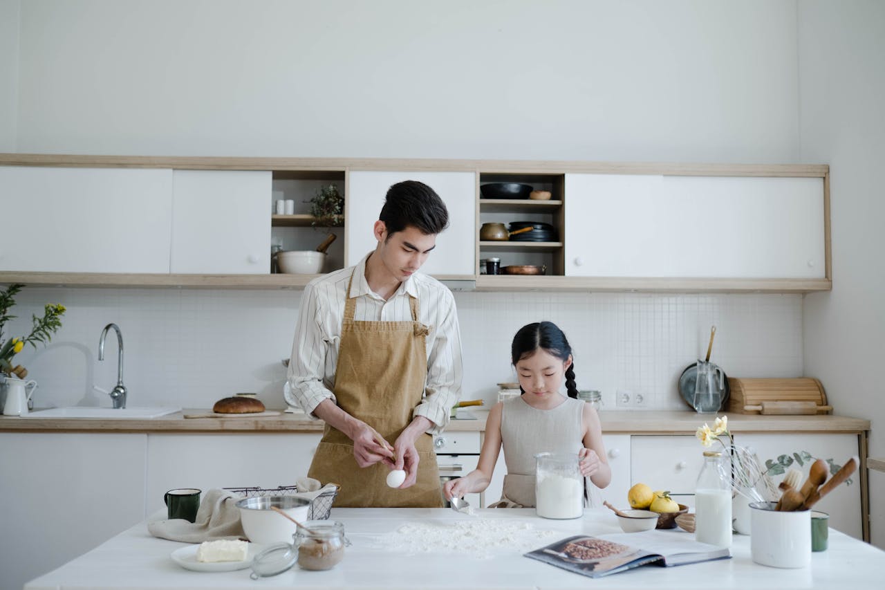 Father adn daughter cooking together.