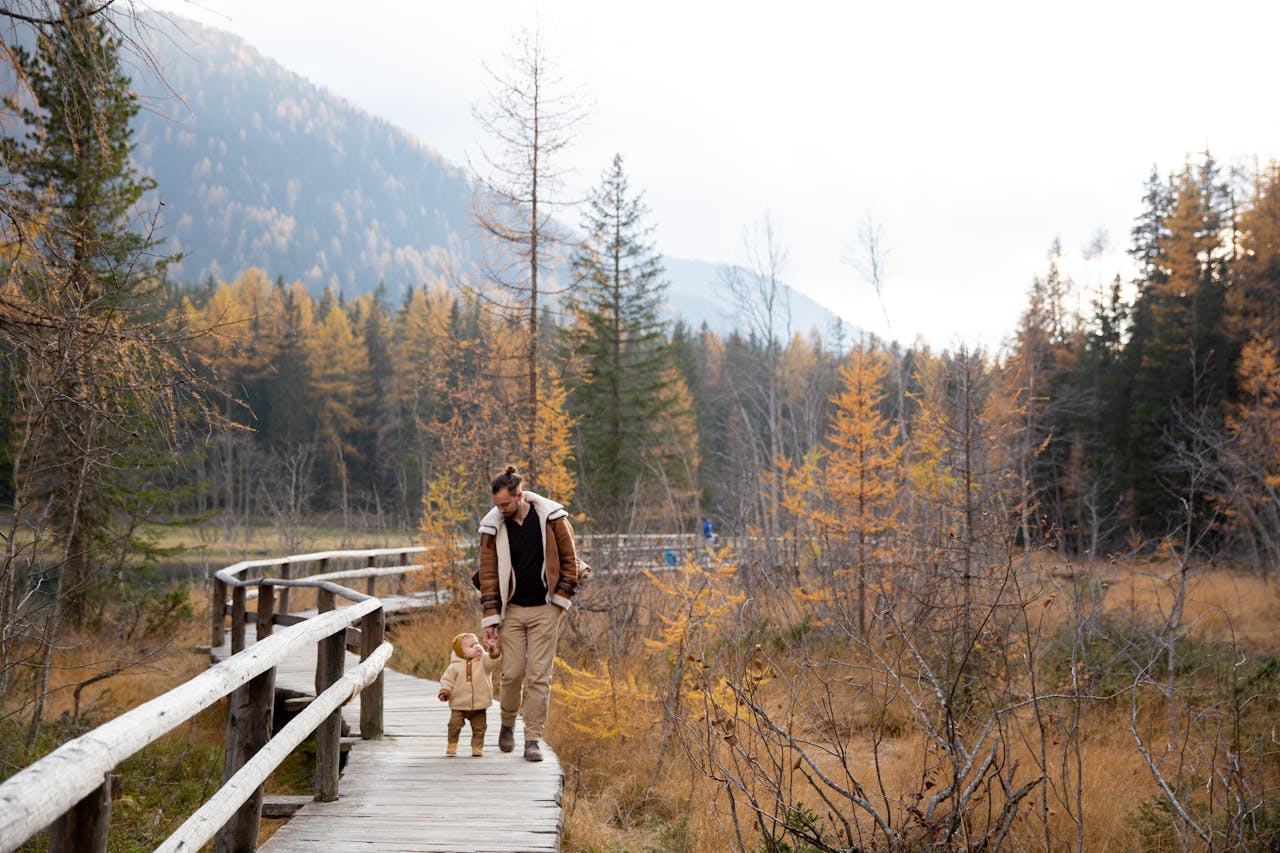 Father and faughter on a hike in a park.