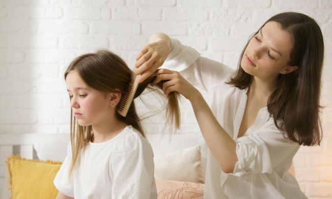 Mom styling young girl's hair