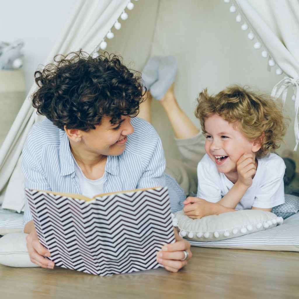 Mother and son reading a book together.