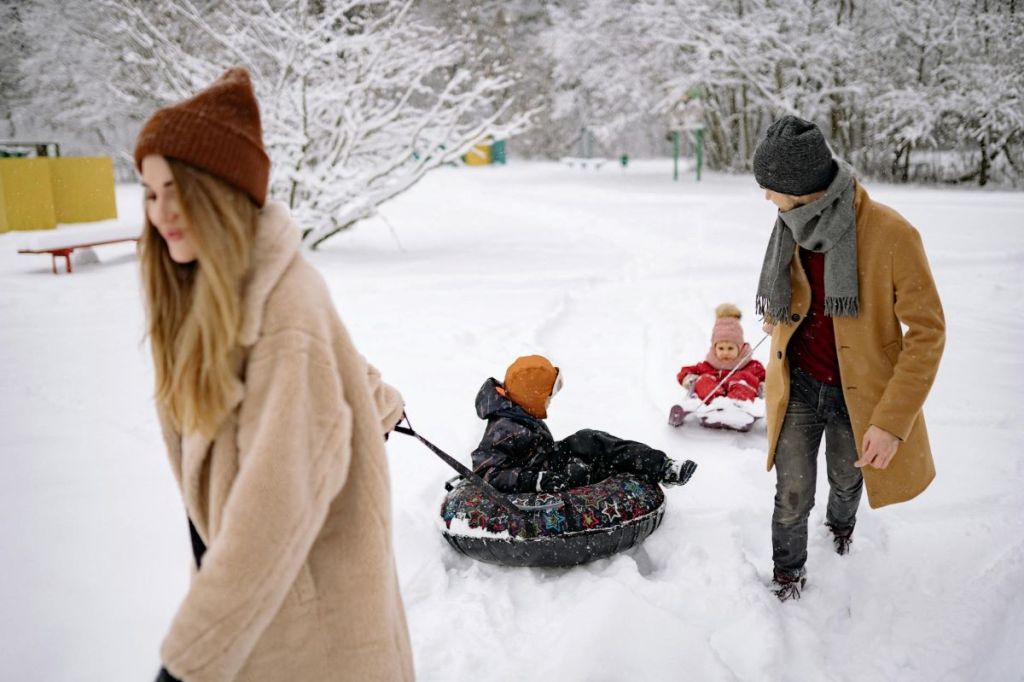 family having fun tubing in winter
