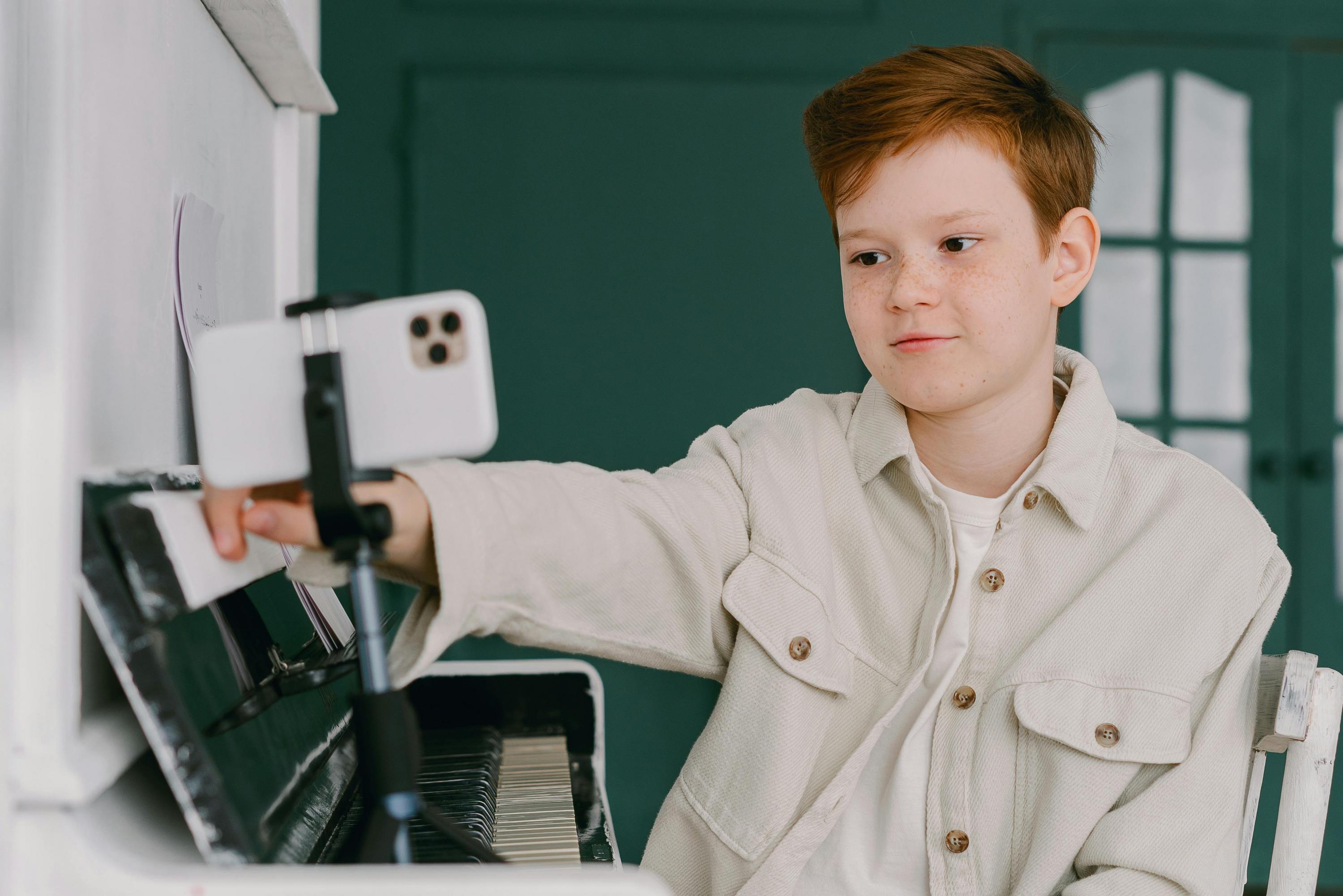Boy filming content using smartphone