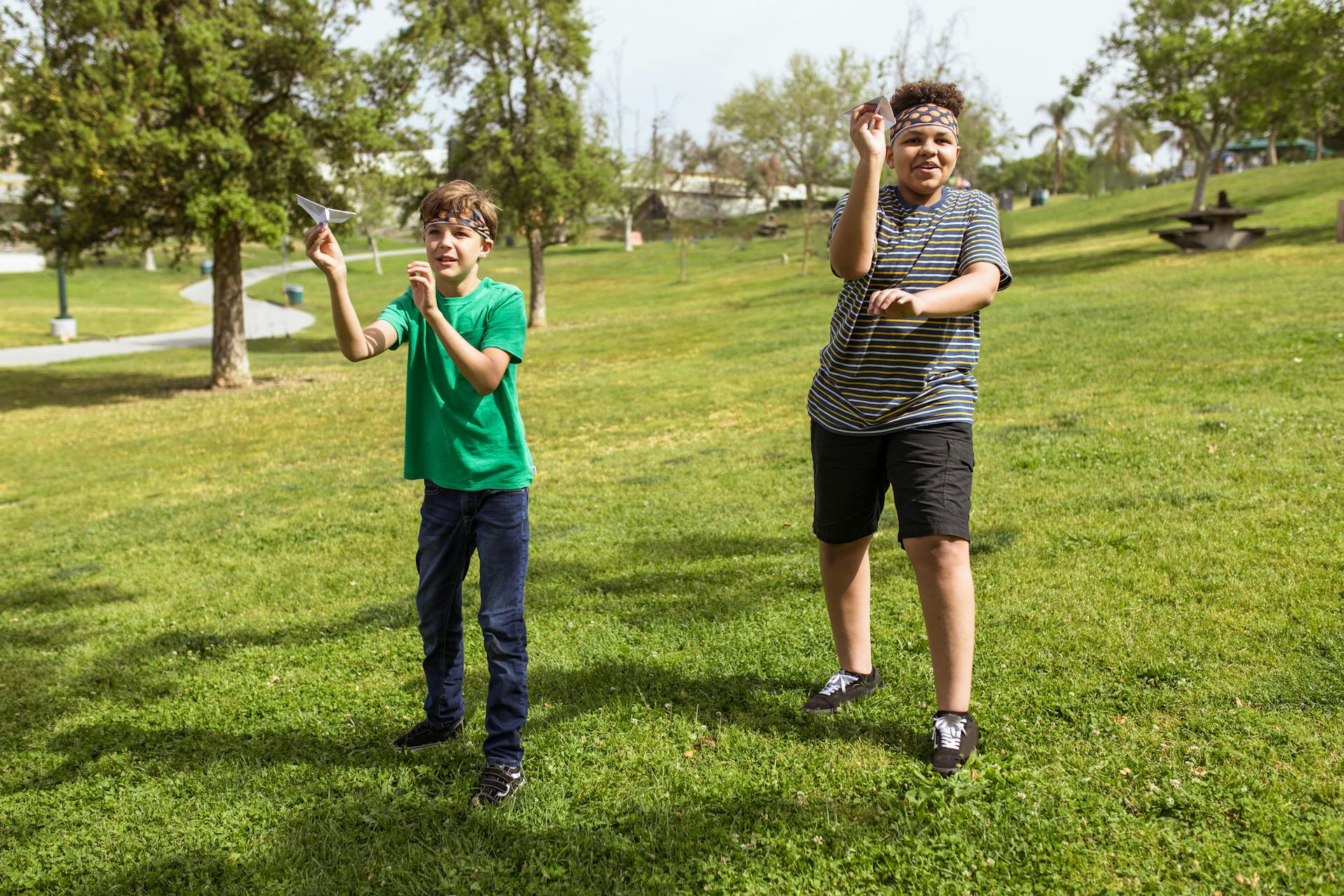 Kids flying paper airplanes.