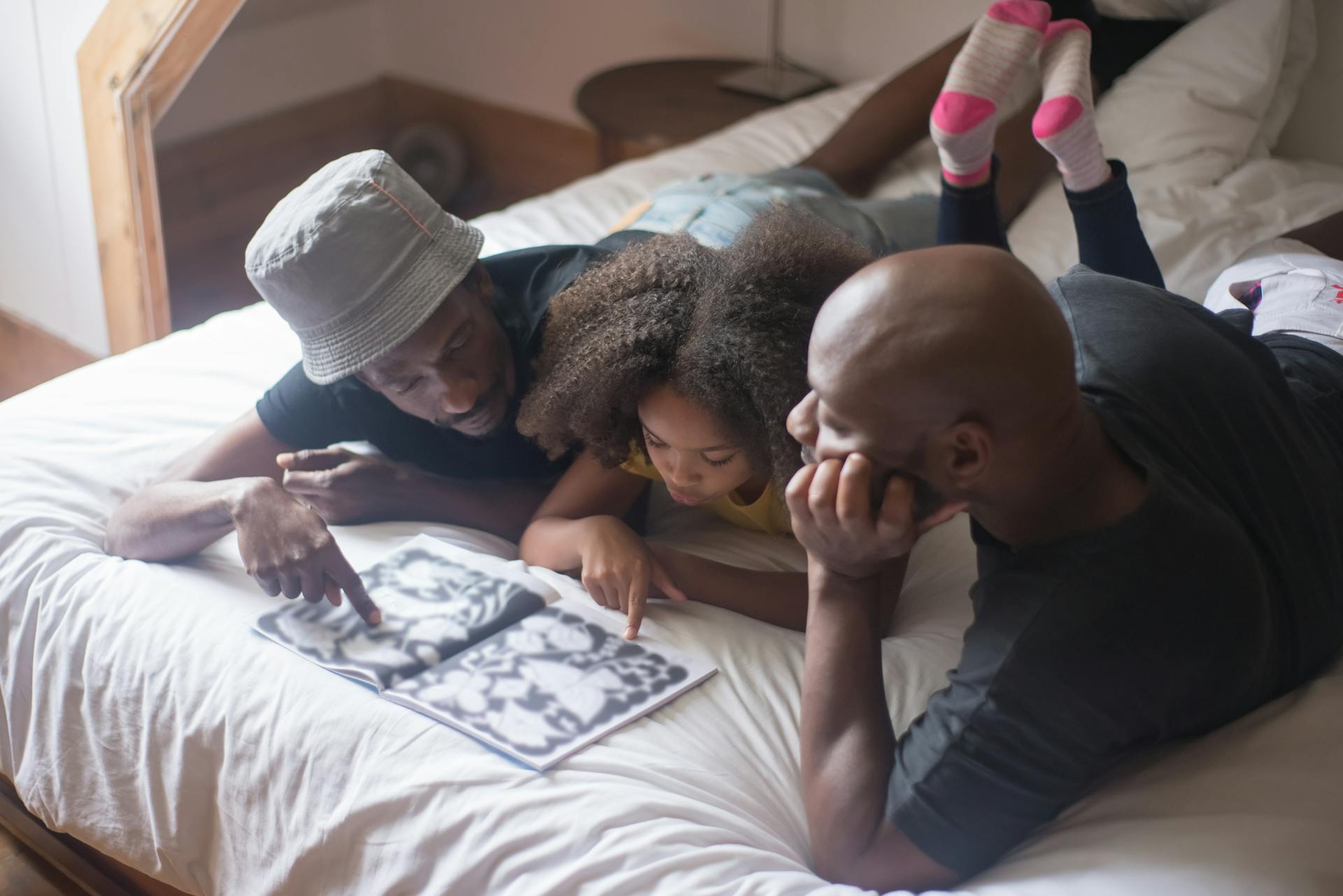 Parent reading with child while lying down.