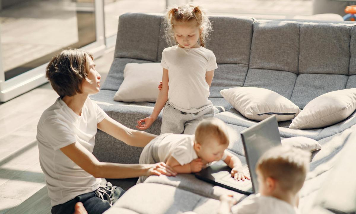 Parent talking with child while watch other kids