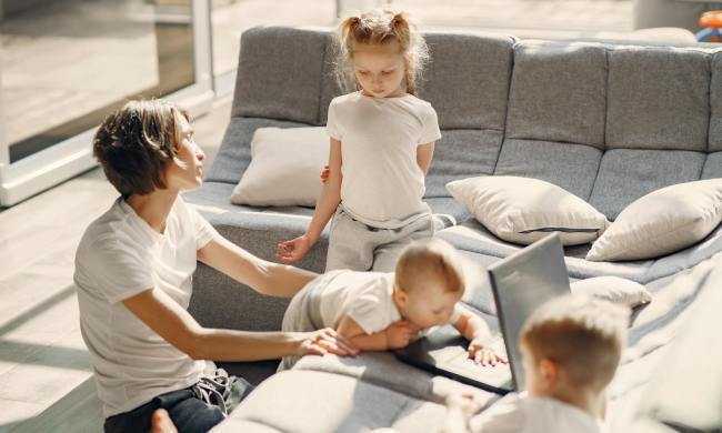 Parent talking with child while watch other kids