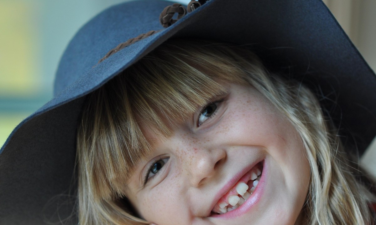 Young girl smiling and showing her teeth